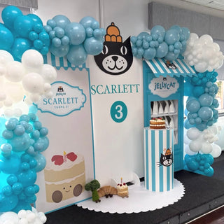 Jellycat Birthday Backdrop | Blue balloon setup with personalised panels, shop display, cake plinth and themed props