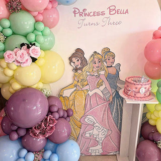 Disney Princess Birthday Backdrop | Pastel balloon display with princess character cut-outs, flowers and cake table