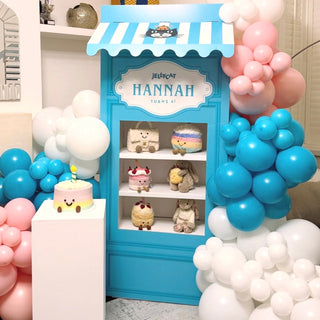 Jellycat Birthday Display | Personalised blue shop backdrop with plush toys, cake stand and pink and blue balloons