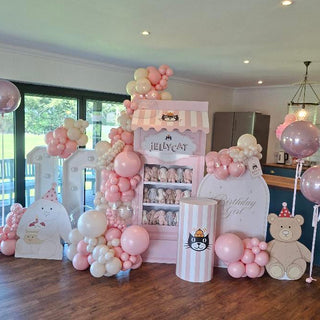 Jellycat Birthday Display | Pink shop backdrop with pastel balloons, plush toy cut-outs and matching cake stand