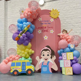 Ms Rachel Birthday Backdrop | Colourful balloon display with character cut-outs, school bus and alphabet blocks