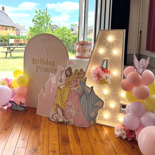 Princess Birthday Backdrop | Pink party display with princess cut-outs, pastel balloons and illuminated number four