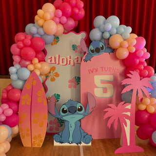 Stitch Birthday Backdrop | Tropical pink balloon display with Stitch cut-outs, surfboard and palm tree props