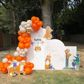Tiger Who Came to Tea Birthday Backdrop | Orange balloon display with tiger cut-outs and storybook party props